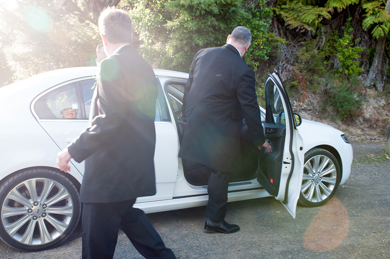 Groom ready to drive into the sunset Homosexual Home garden Wedding Auckland Photographer Anais Chaine