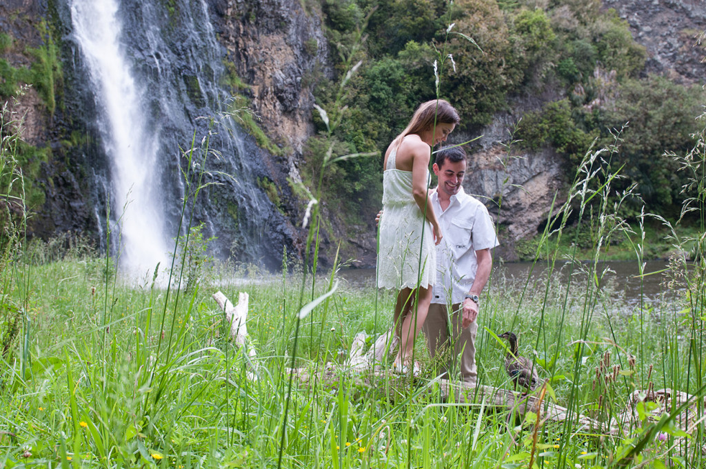 in front of the hunua falls the couple chatting with a duck