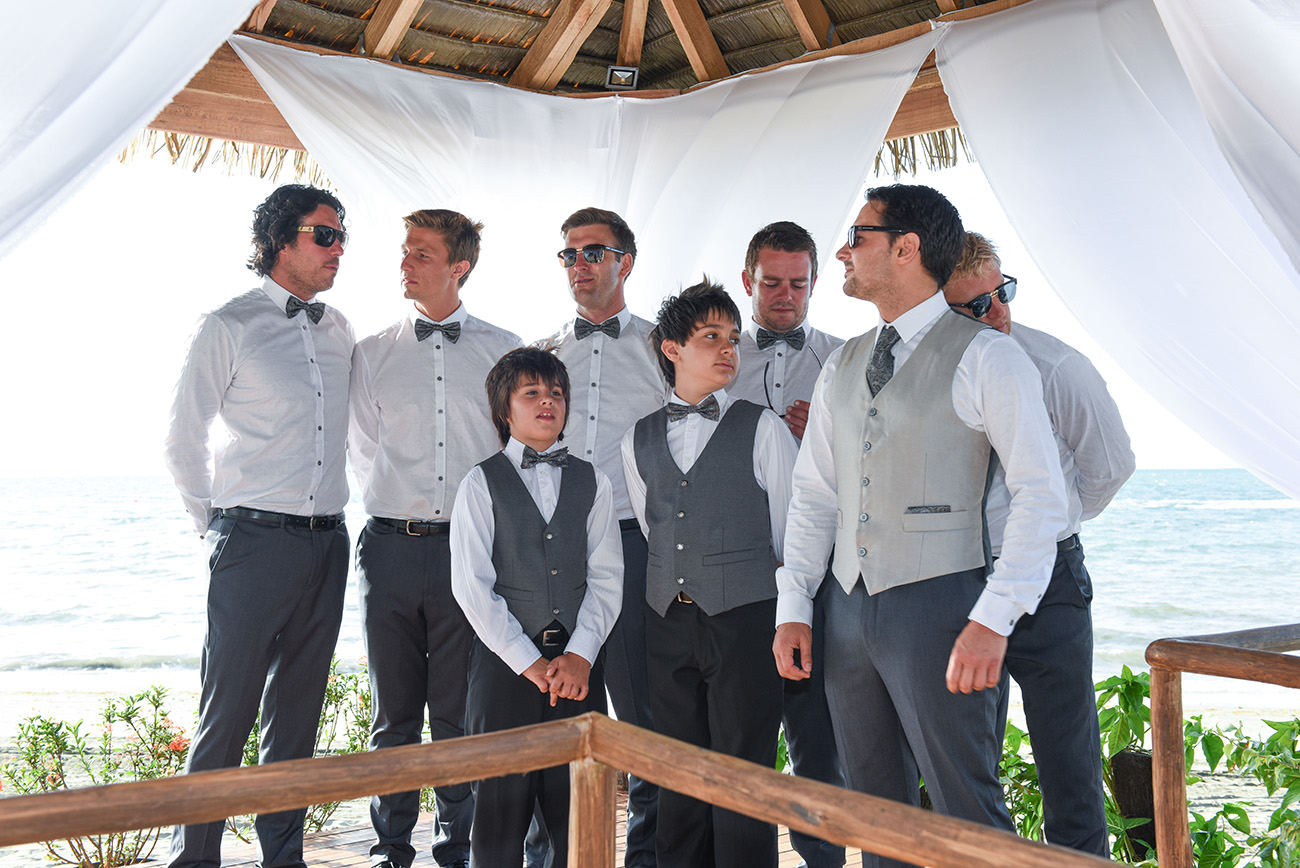Inside the beach hut the groom and his groomsmen expecting the bride and beginning of the ceremony