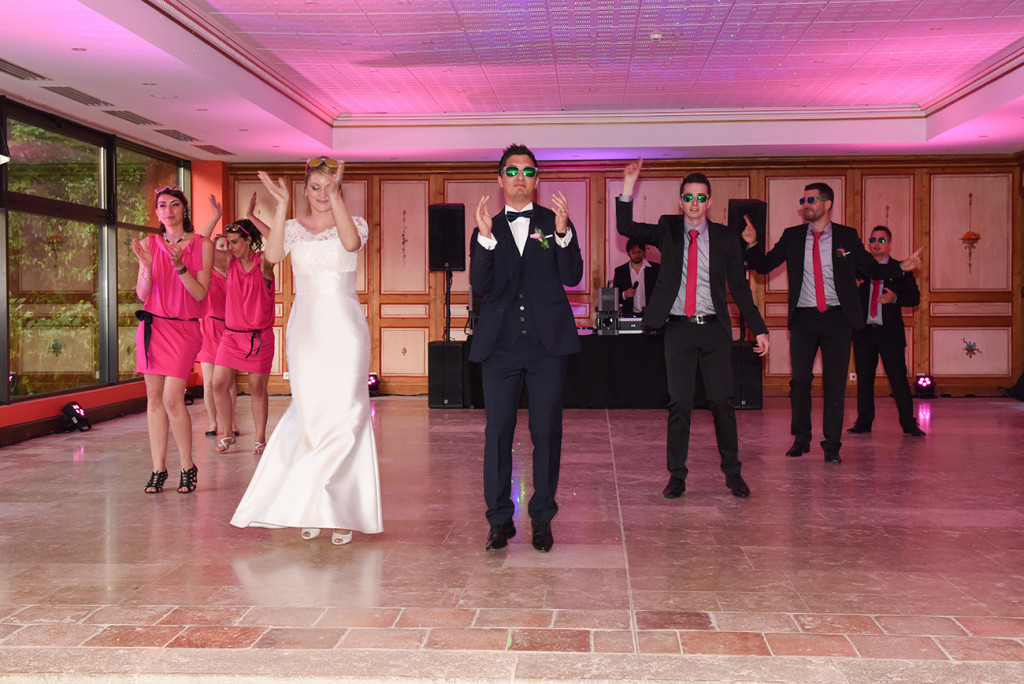 The bride and groom and their bridesmaids and groomsmen dancing at the beginning of the reception