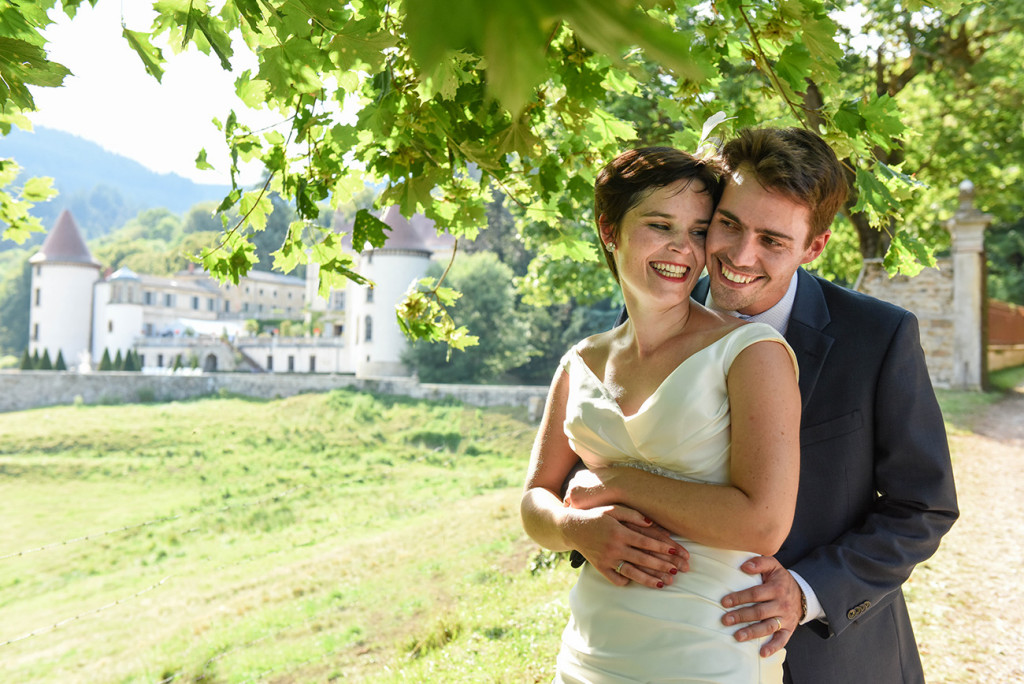 Bride and groom laugh at photoshoot at their outdoor French Wedding in Pranemoux Castle France French photographer