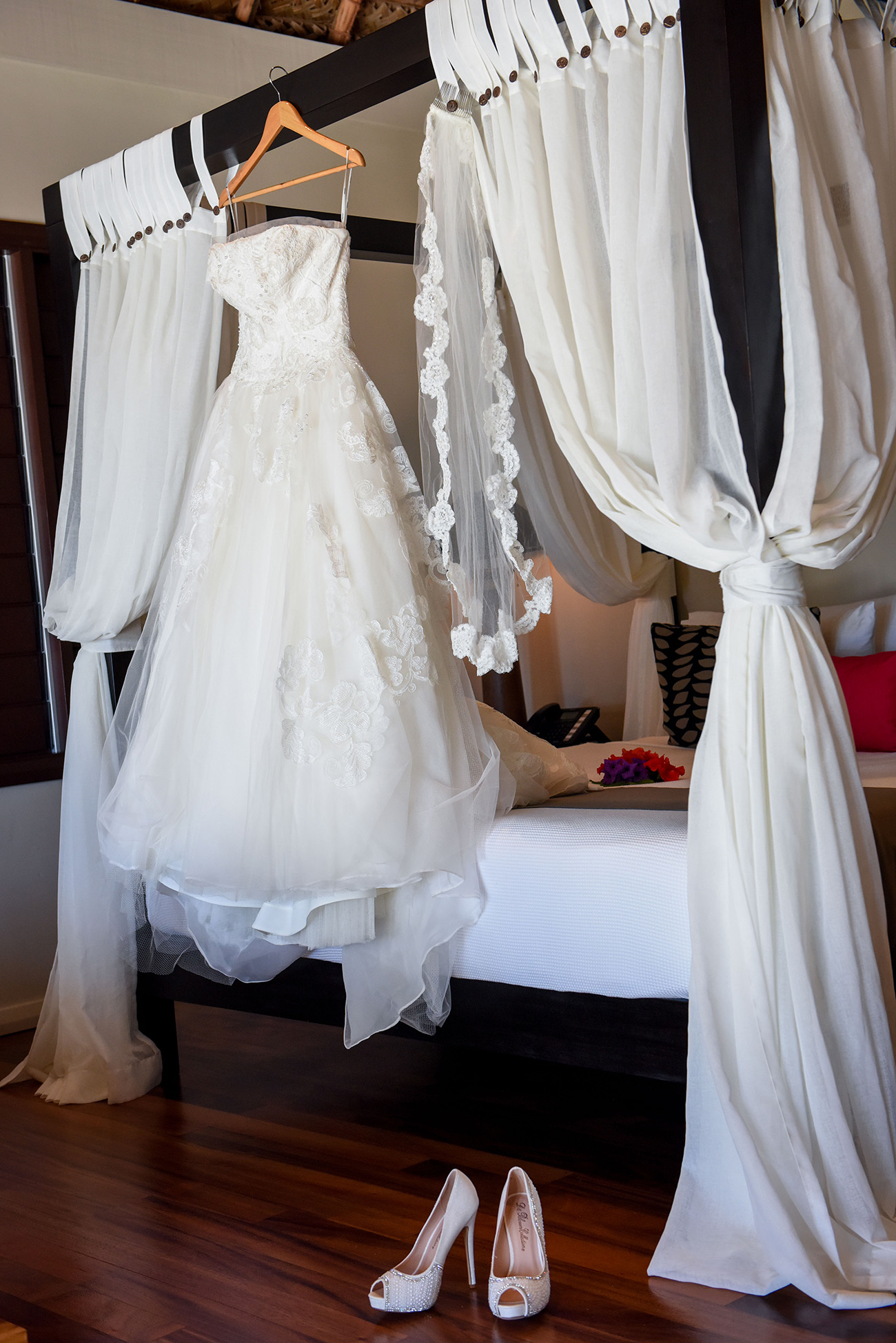 The wedding dress hanging on the beautiful bed of the villa at Paradise Cove Island Resort in the Yasawas in Fiji