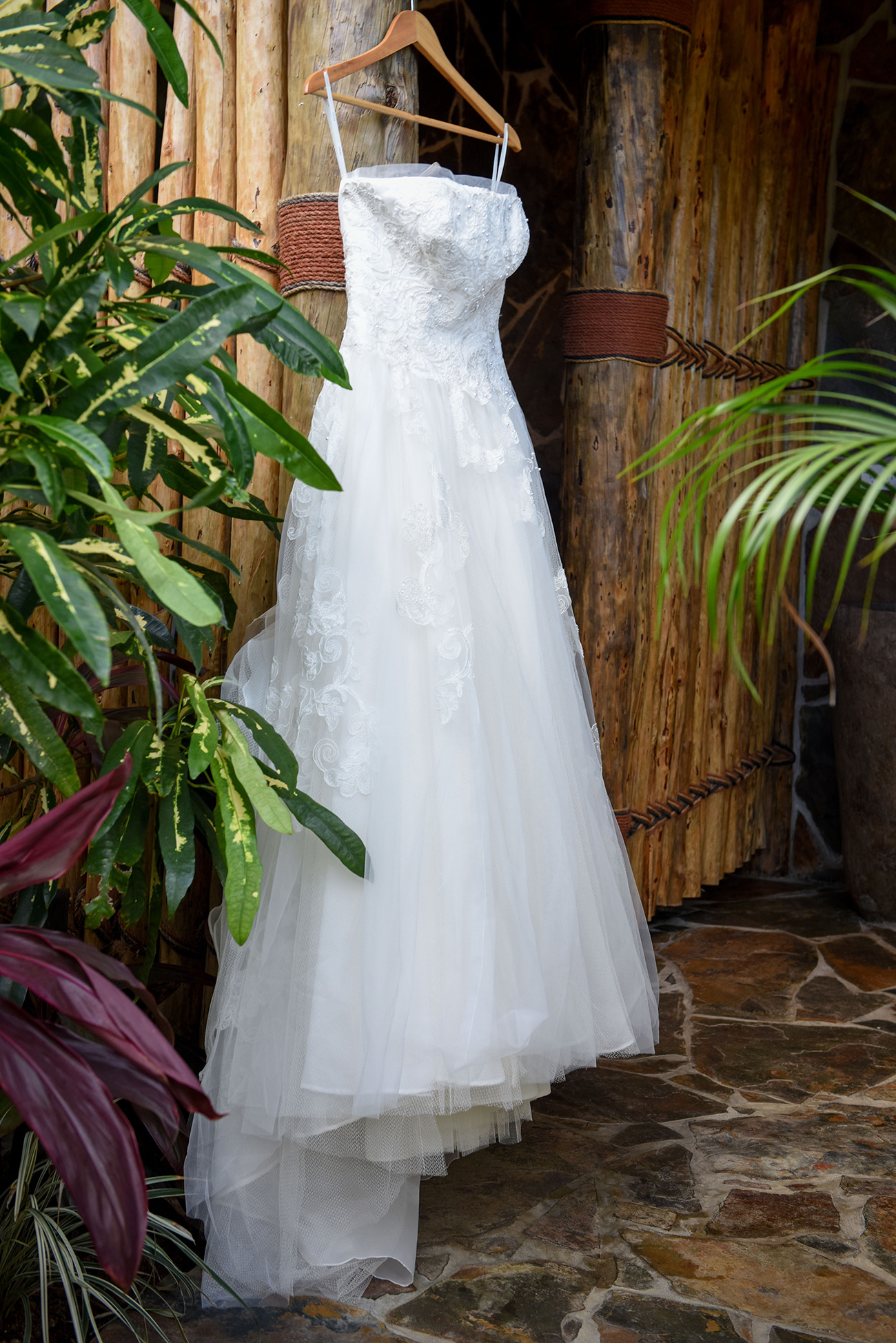 Wedding dress hanging with tropical greens At Paradise Cove Island resort in the Yasawas, Fiji