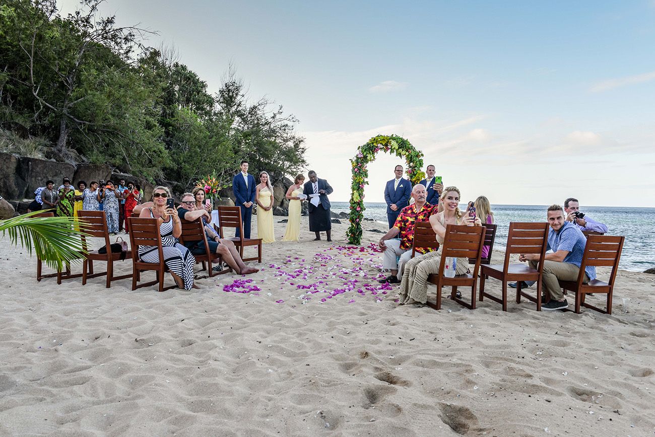 The groom and the guests are all watching the bride arriving at the ceremony At Paradise Cove Island resort in the Yasawas, Fiji