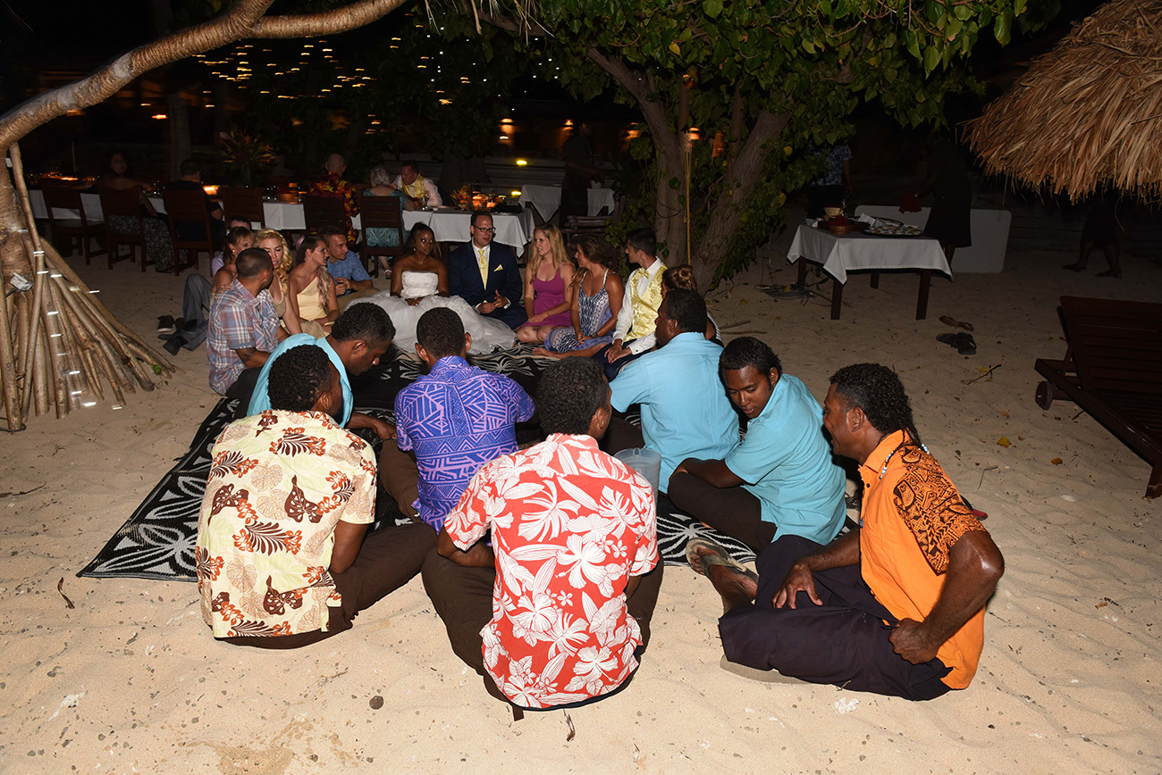The group of guests and local Fijians are sited together doing the kava ceremony