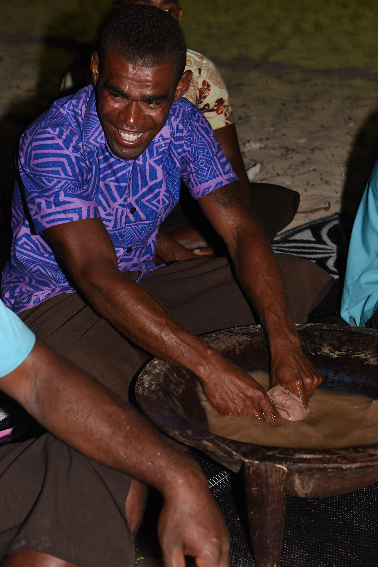 A Fijian is getting the mix ready for the kava ceremony at Paradise Cove island resort in the Yasawas in Fiji photographed by Anais Photography