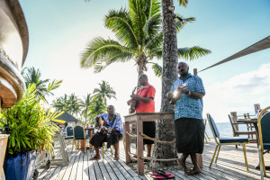 A trio of Fijieans singing local songs by the pool. Photographed by Anais Photography. 