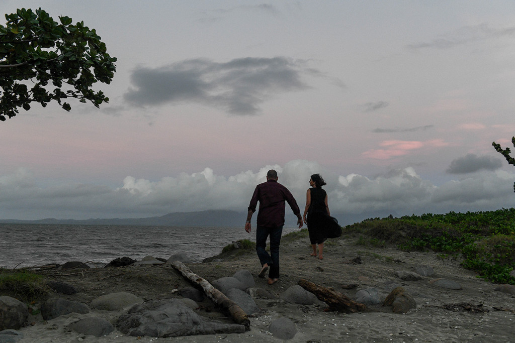 End of the sunset with couple walking up a small dune by the sea at the Sheraton Resort in Denerau Island in Fiji