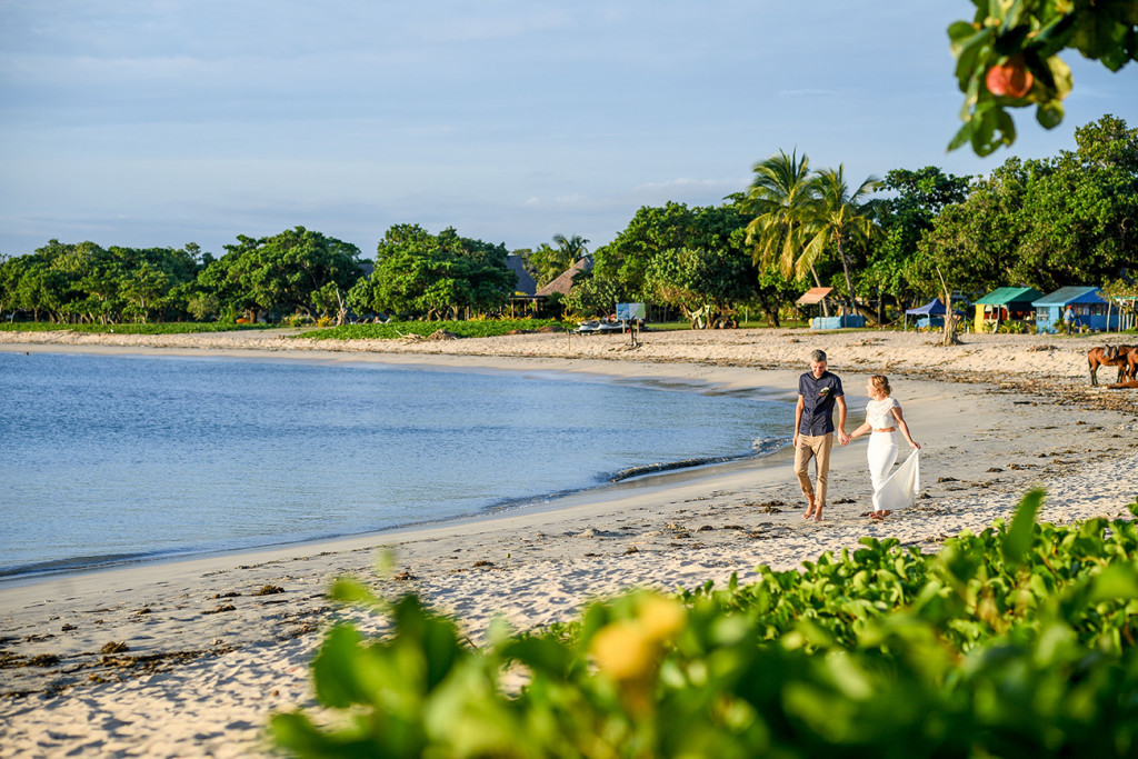 Eloped couple walk down the Coral Coast Fiji