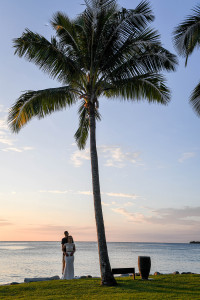 Eloped couple against palm trees in Yatule Fiji Resort