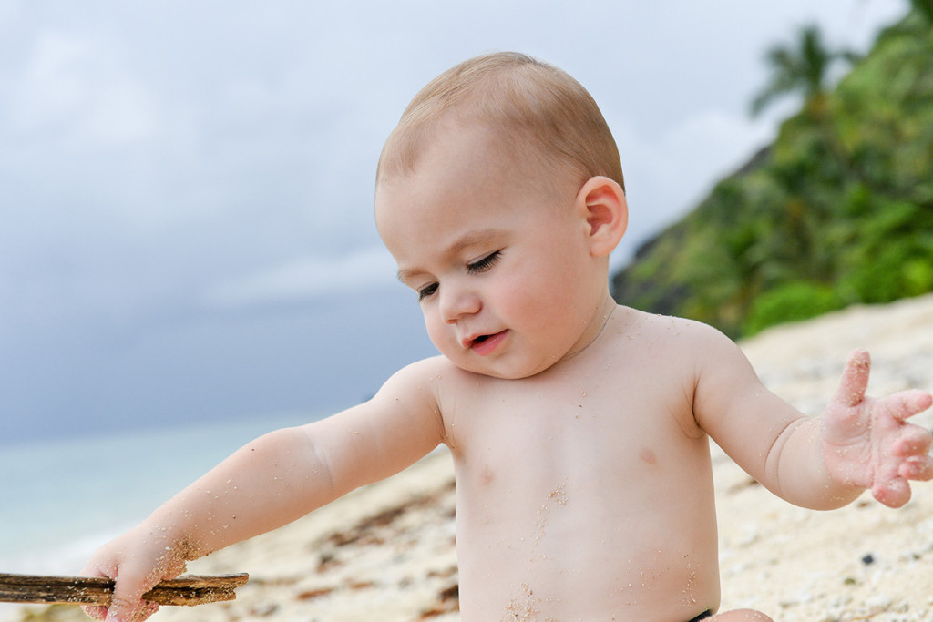 Cute baby playing on the shores of Vomo Island Resort Fiji