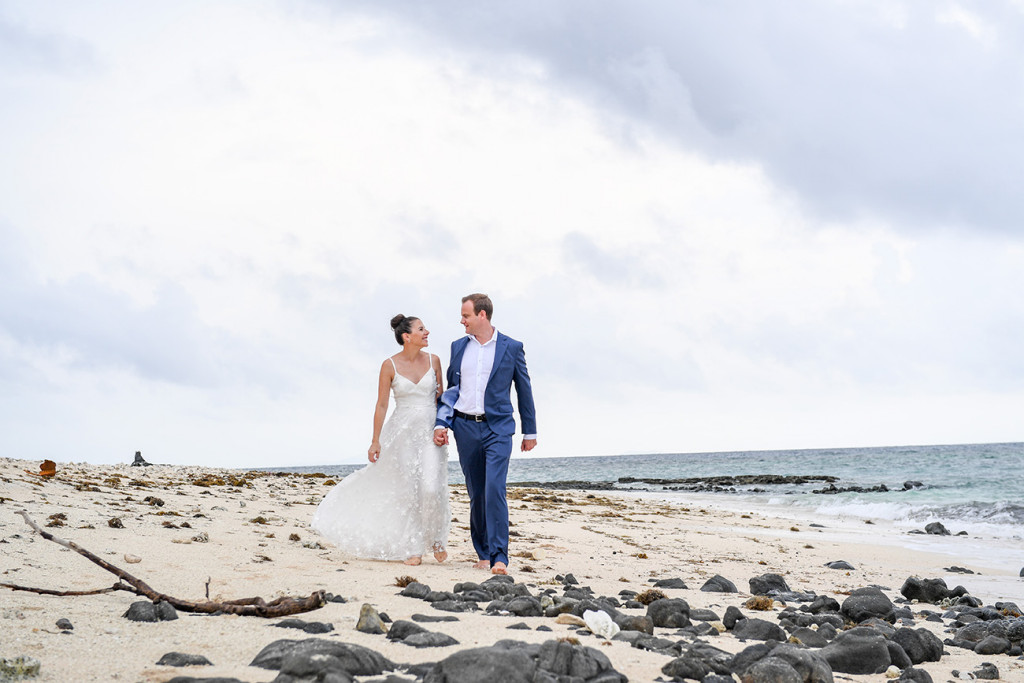 Couple walks down the beach on Vomo Island Resort Fiji