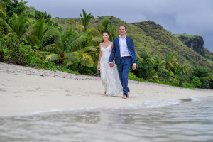 Couple walks by the beach in Vomo Island Resort Fiji