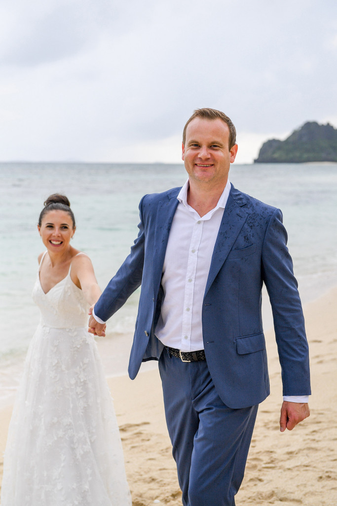 Groom pulling bride in Vomo Island Resort Fiji wedding