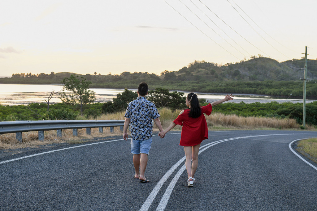 Engaged couple walk down the road on Denerau Island Nadi Fiji