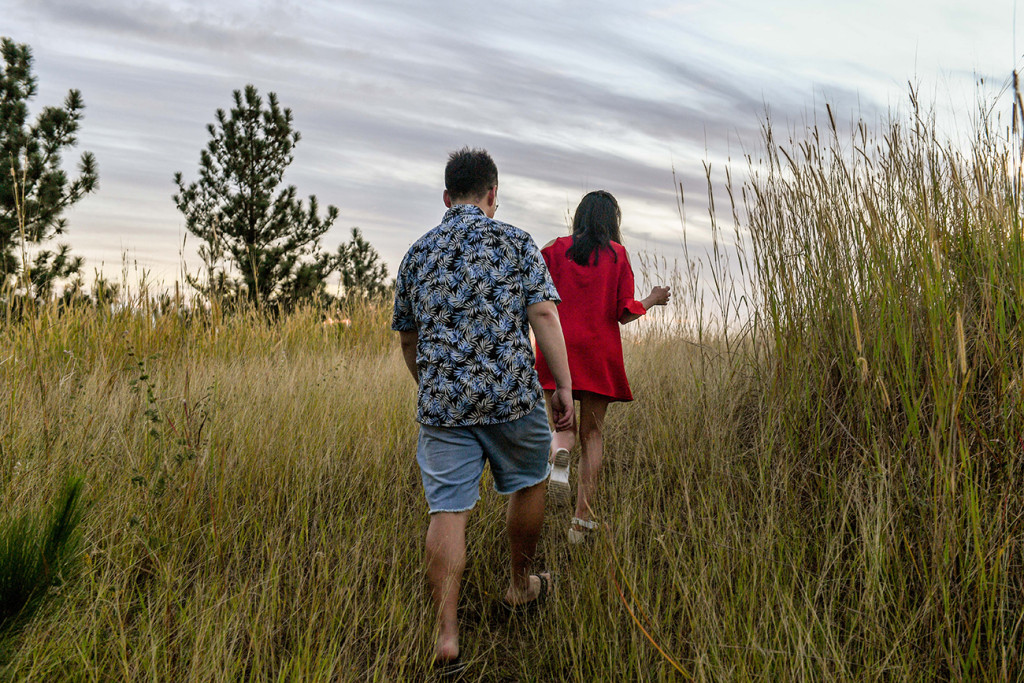 Loving young couple walk in the greenery at Engagement photoshoot in Denarau Island Fiji
