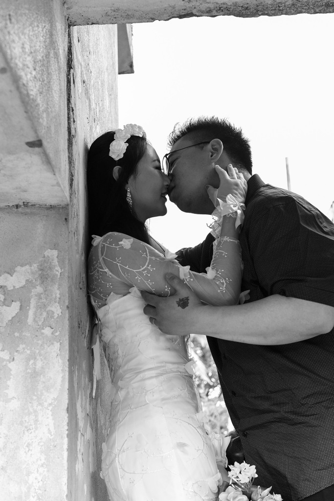 Black and white photograph of asian couple kissing