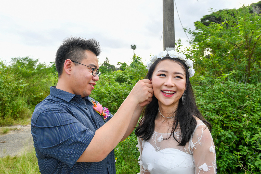 Groom adjusts bride's earring in Warwick Fiji wedding