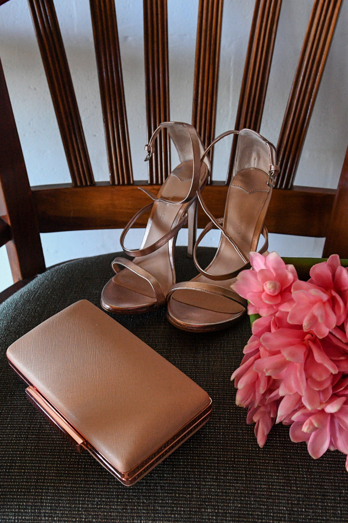 Closeup of bride's silky brown shoes and purse