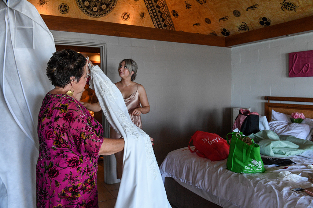 Mom pulls down wedding gown for bride during Fiji wedding