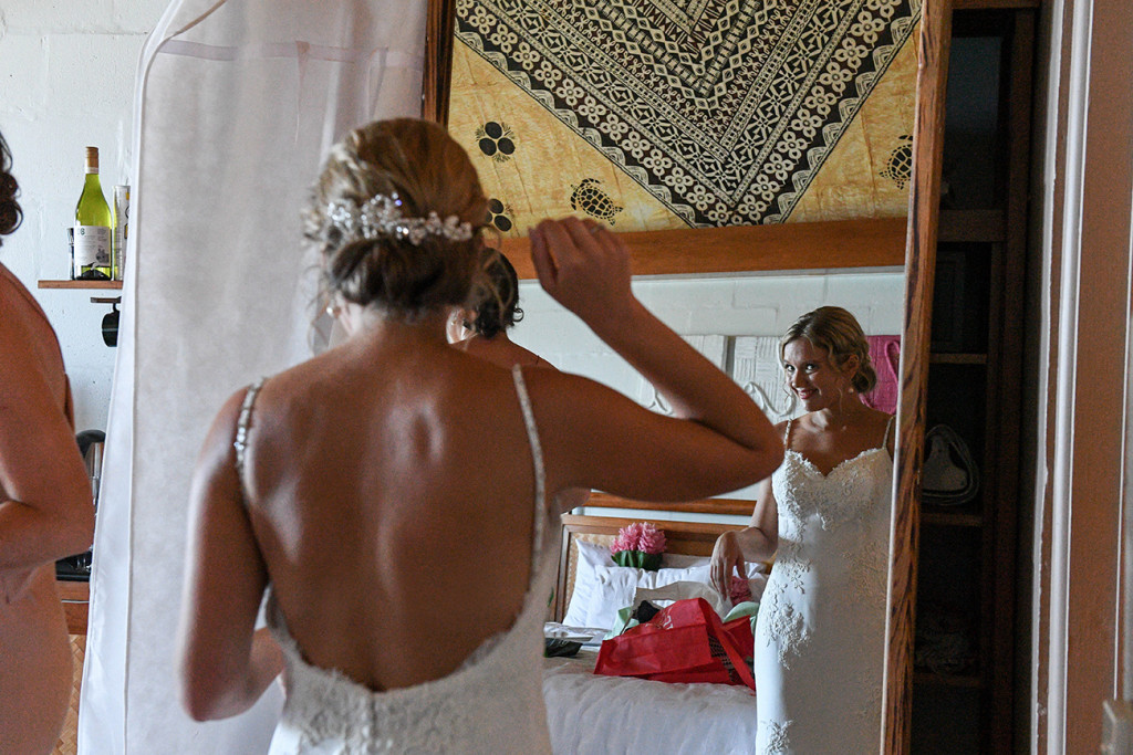 Bride looking at her reflection during wedding prep
