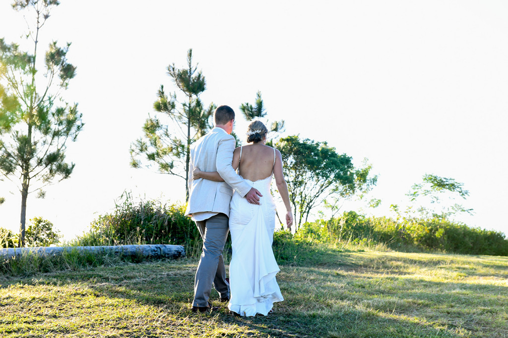 Bride and groom walk on Fiji countryside