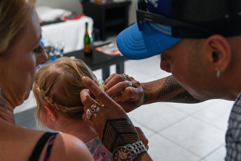 Renowned hair stylist braiding flower girl's hair Fiji