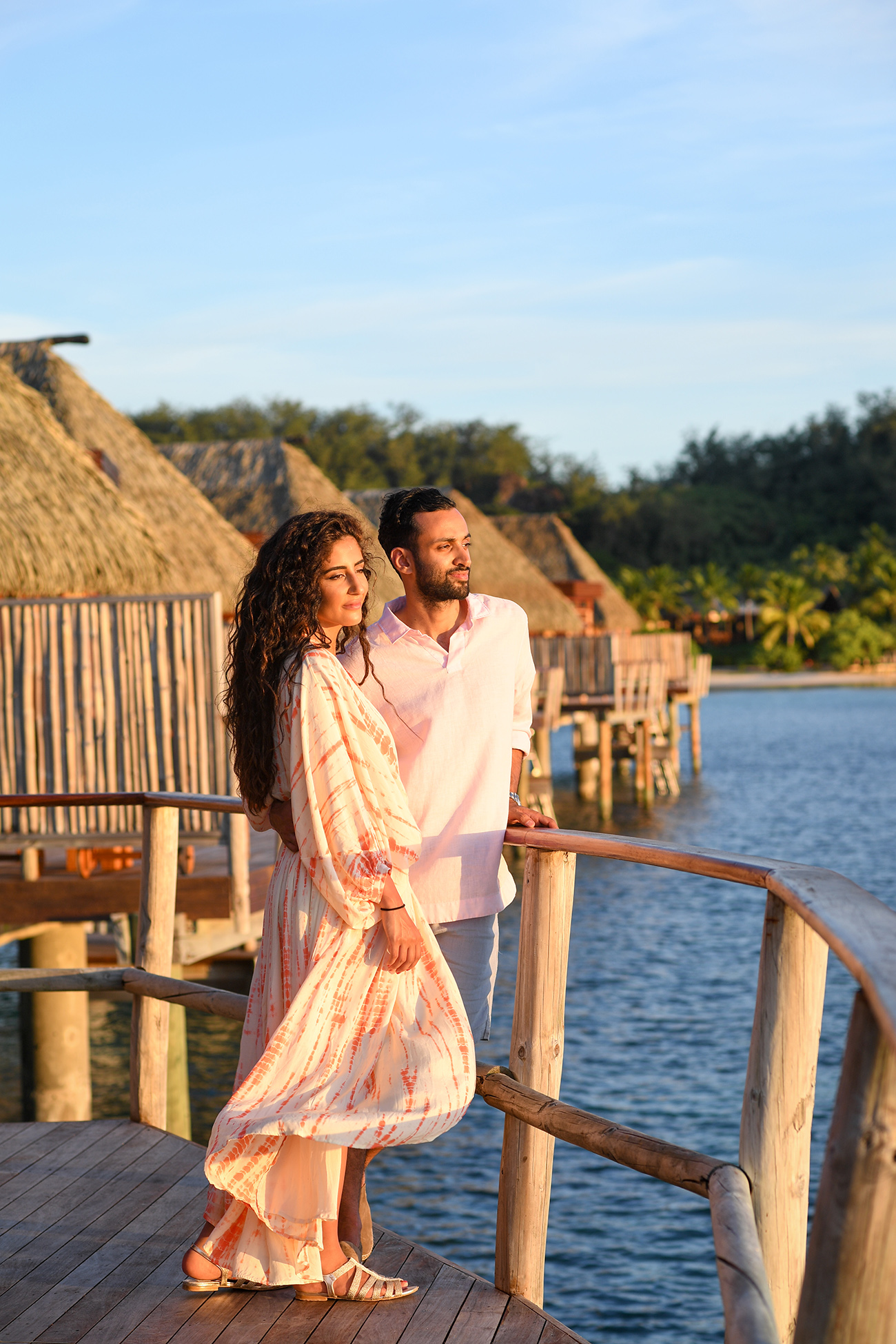 Stunning couple look into the sunset at the edge of Villa in Likuliku Resort