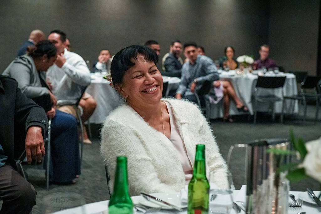 A wedding guest bursts out laughing