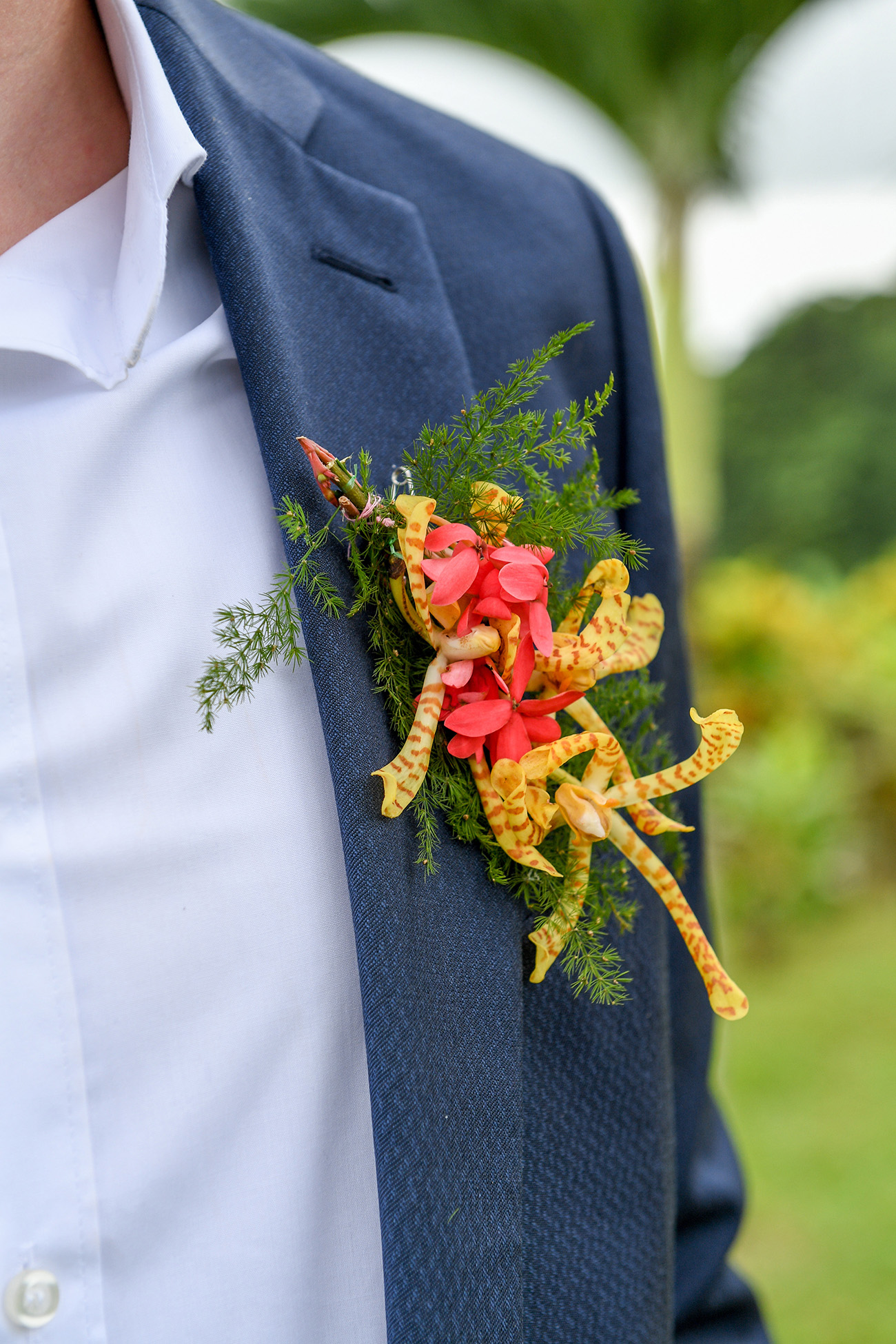 Closeup of native Fiji flower boutonniere on groom