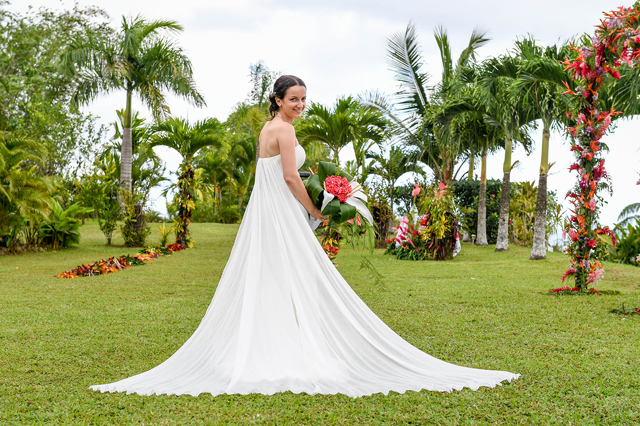 Stunning large white gown of German bride on the green lawn of Savusavu Island Fiji