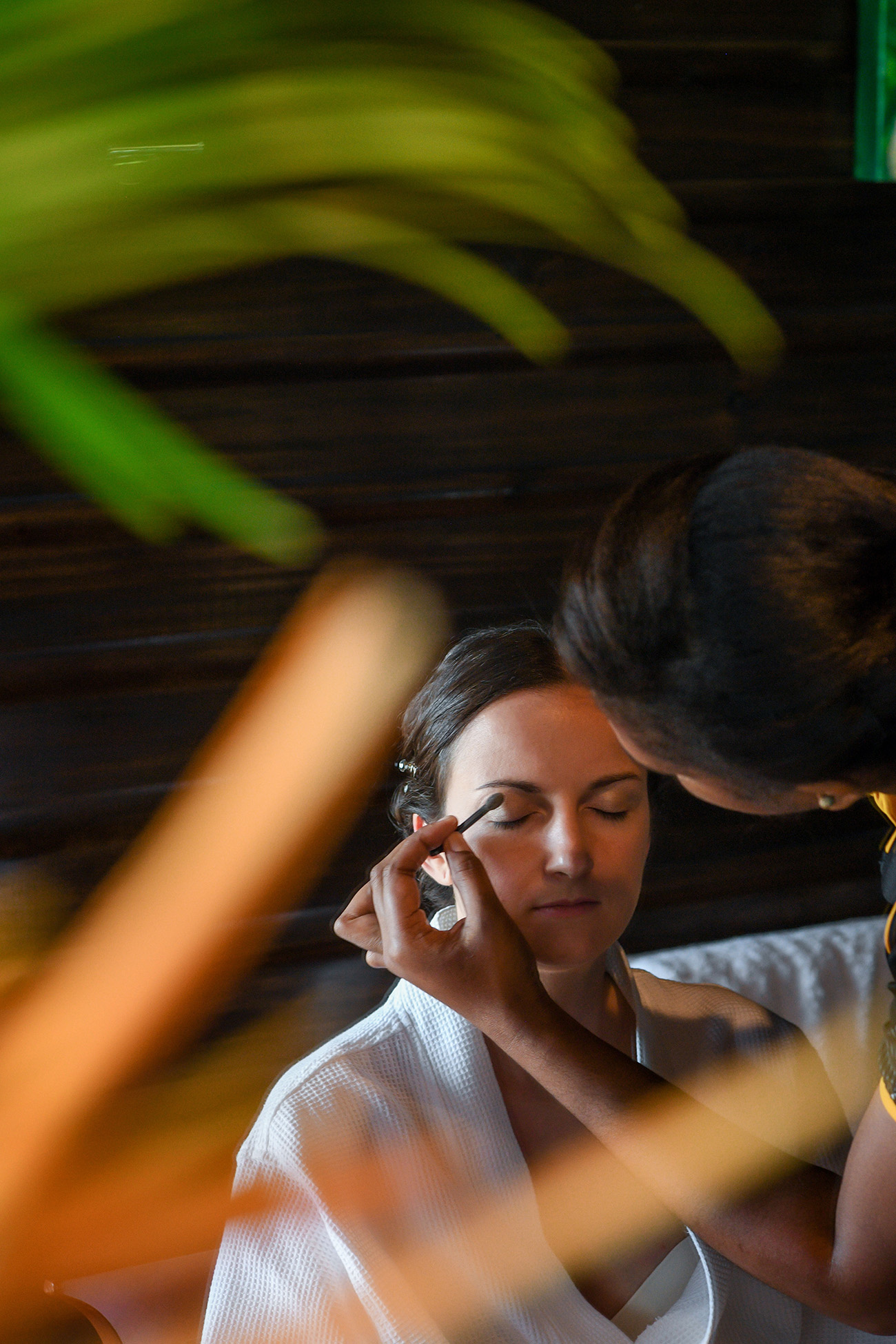 Bride's eyebrows being done by makeup artist