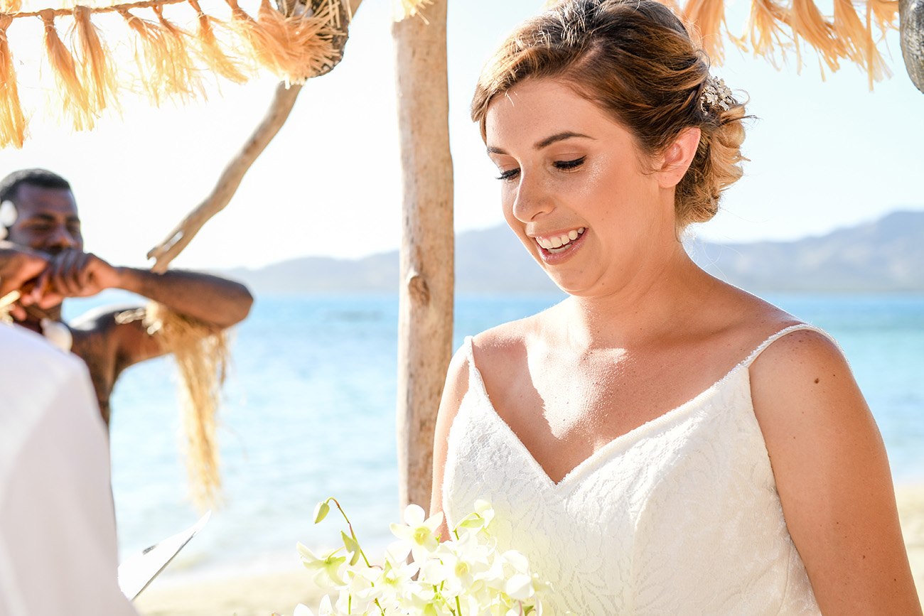 Closeup of the stunning bride saying her vows against the Fiji Sea