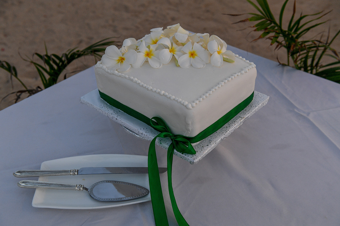 Simple wedding cake decorated with tropical Fiji flowers