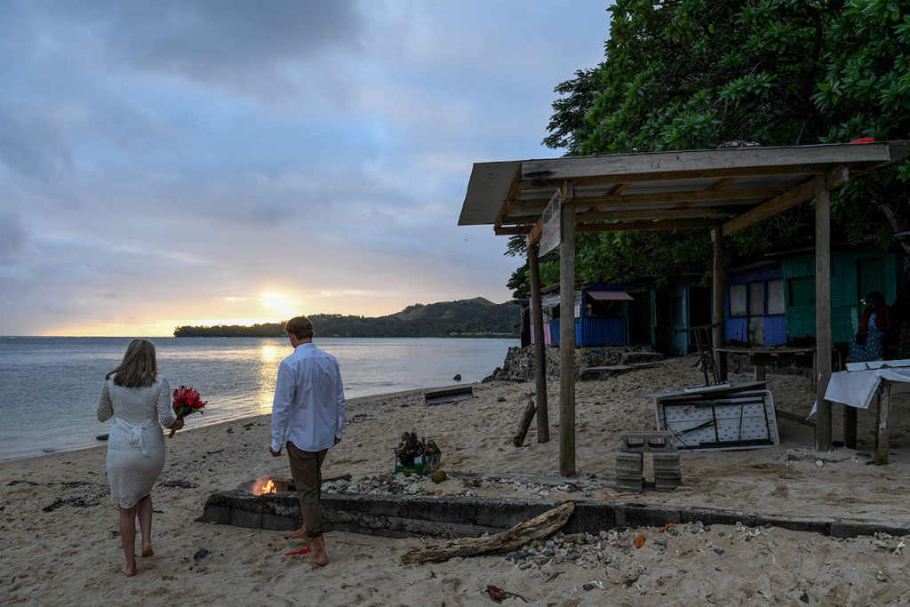The bride and groom at sunset on the Fiji beach