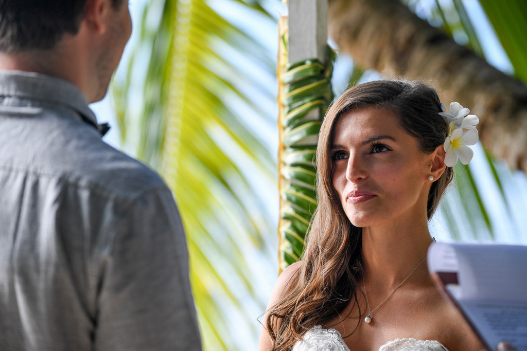 Portrait of the bride looking at the groom during the wedding ceremony, Matangi island resort, Fiji