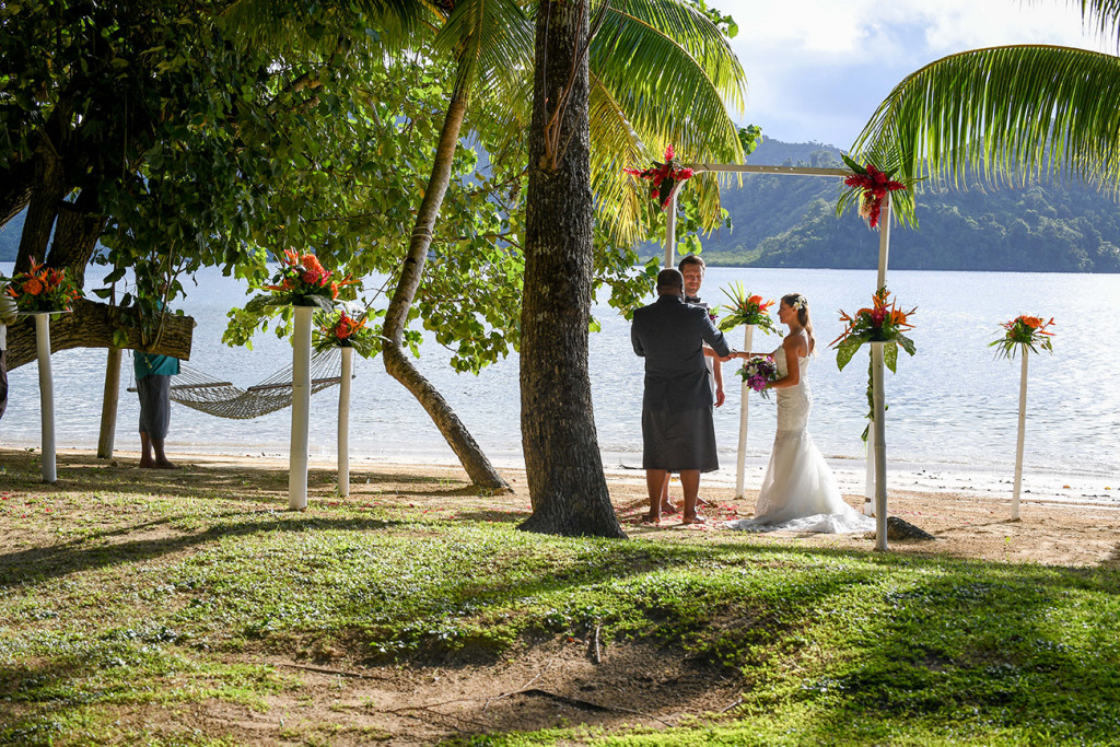 Wedding ceremony by the beach and palm trees at Matangi island resort, Fiji