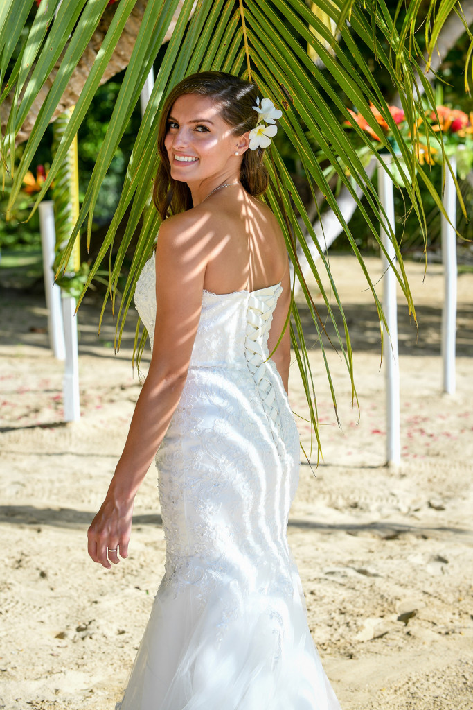 Bride's back with the shade of a palm tree on her back, Matangi island Fiji