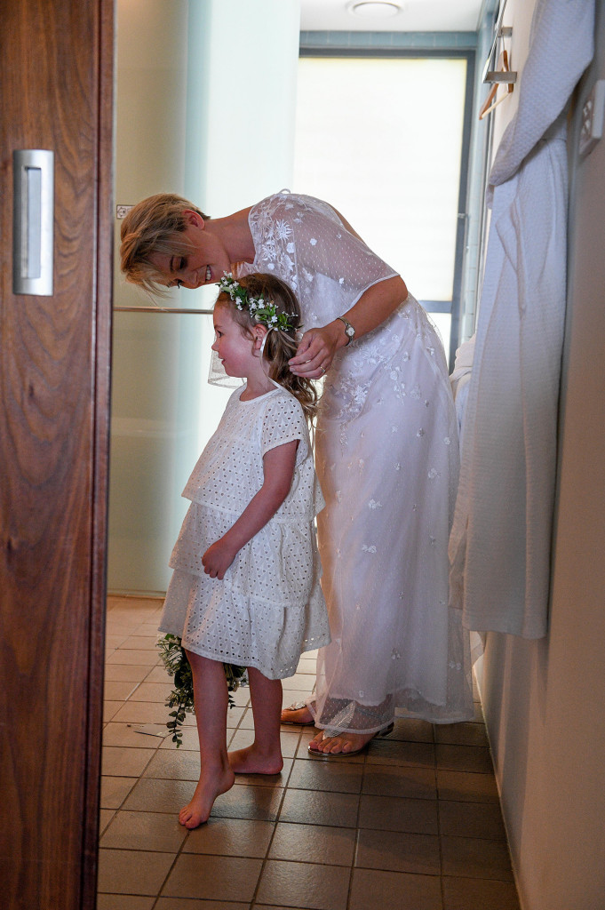 Bride adjusting the flowergirl's flower crown