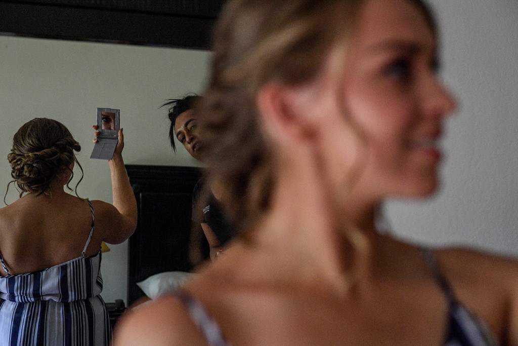 Bride checking out her makeup through a pocket mirror