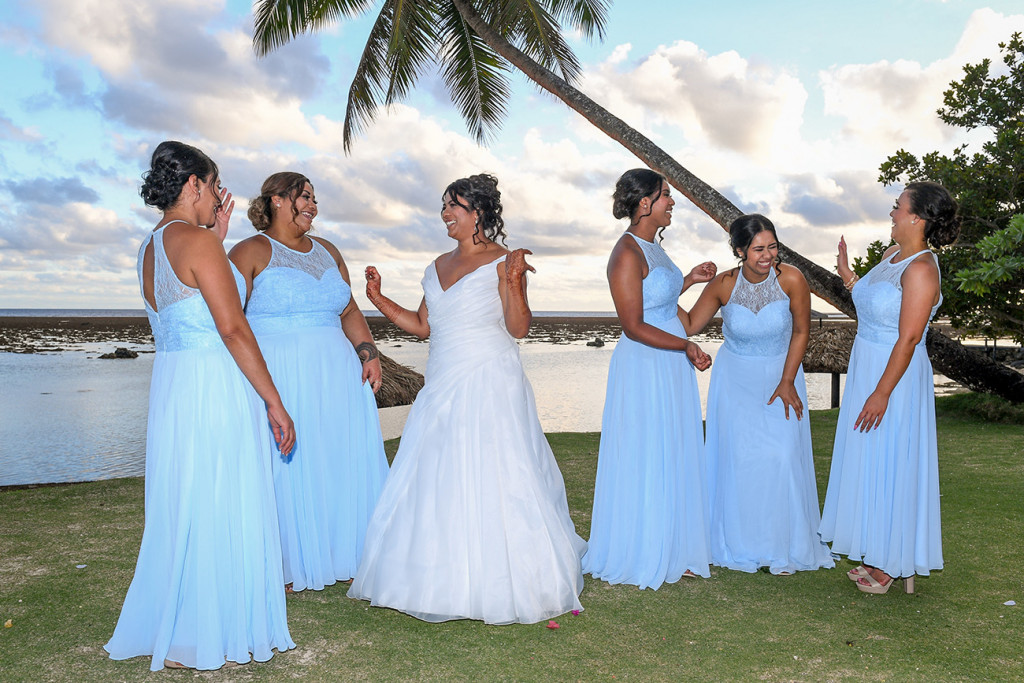 The bride and her bridesmaids laugh in the moment