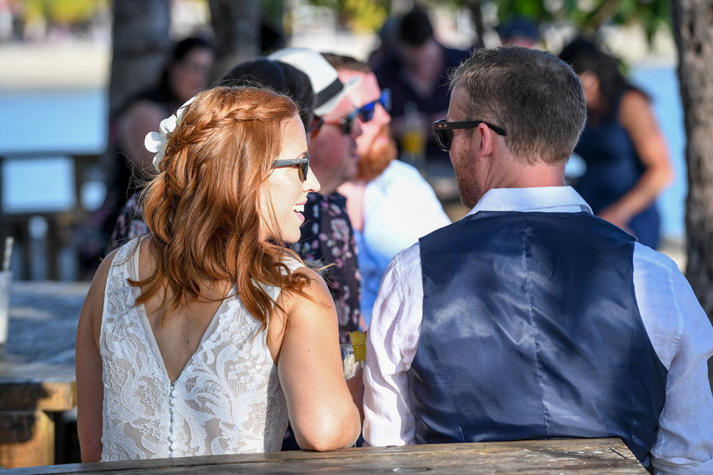 The bride and groom enjoy the sun at their relaxed outdoor wedding