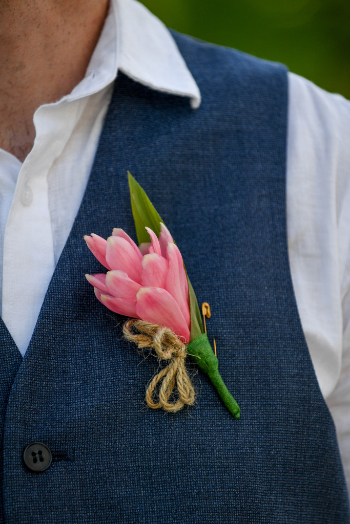 Simple pink tropical ginger flower boutonniere on custom Ballantynes suit