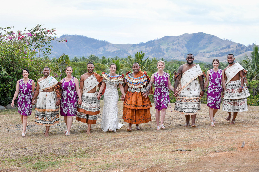 Traditional Fiji bridesmaids and groomsmen lineup against Fiji hills