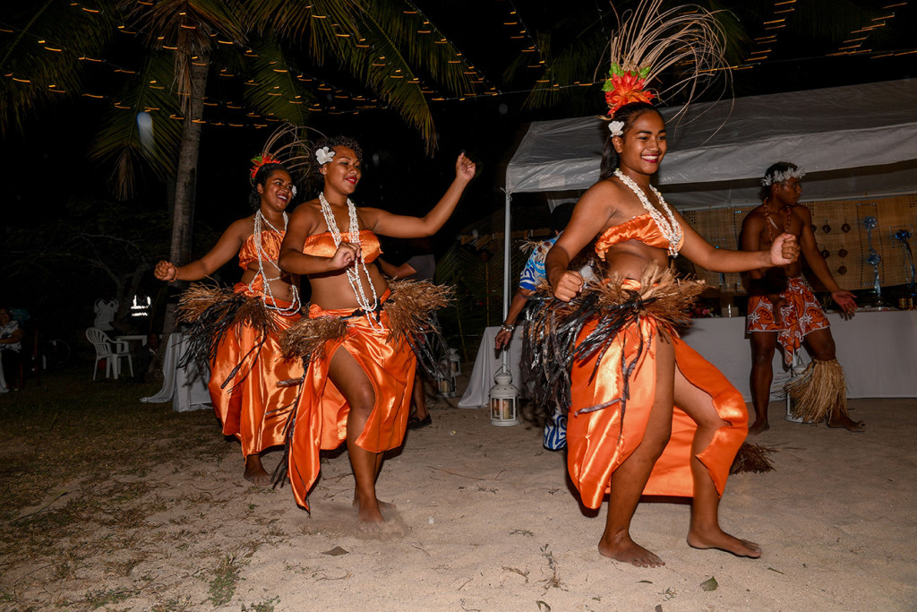 Female Performers dressed in brilliant orange dance take the dance floor