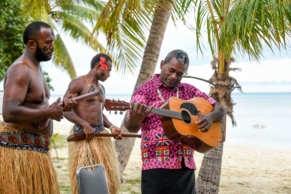 A Fiji guitarist strums the guitar at the wedding ceremony