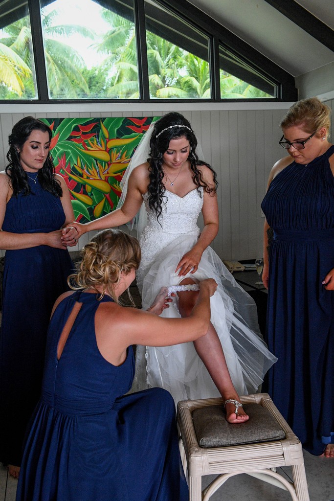 The bride slips on the wedding garter