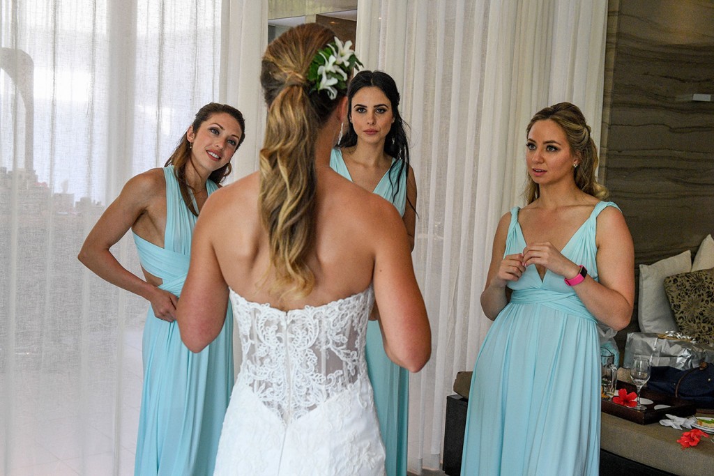 The bride shows her bridesmaids her look one last time