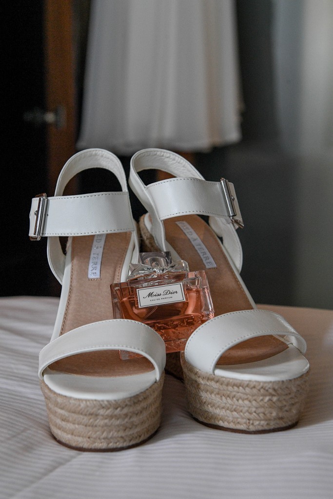 The bride's Miss Dior scent rests on her white block wedding heels