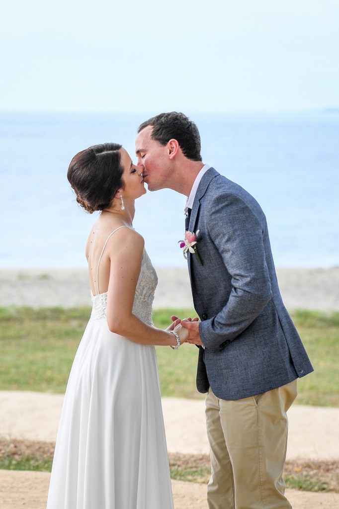 The couple shares a magical kiss overlooking the beach at Hilton Denarau Fiji